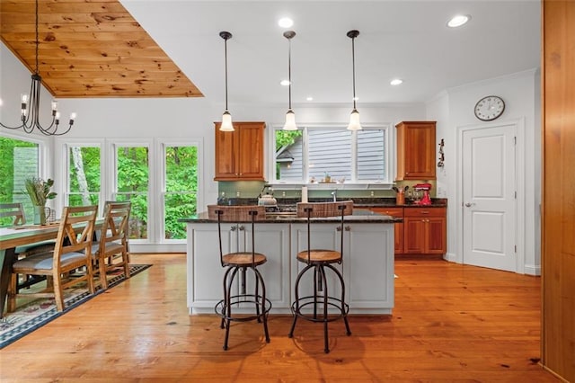74 Cherokee Way, Big Canoe, GA 30143 - kitchen with brown cabinets, a breakfast bar, plenty of natural light, and a center island