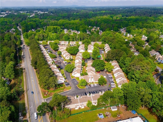 aerial overview of property's location with a forest and nearby suburban area