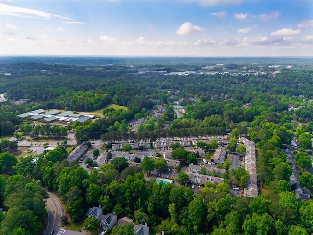 aerial overview of property's location with a heavily wooded area