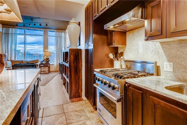 1820 Peachtree St NW Unit 811, Atlanta, GA 30309 - kitchen with ventilation hood, stainless steel stove, tasteful backsplash, light stone counters, and wine cooler