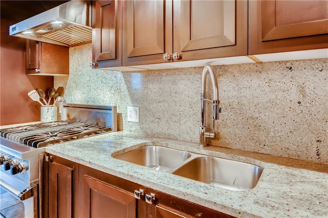 1820 Peachtree St NW Unit 811, Atlanta, GA 30309 - kitchen with a sink, stainless steel gas stove, range hood, tasteful backsplash, and light stone countertops
