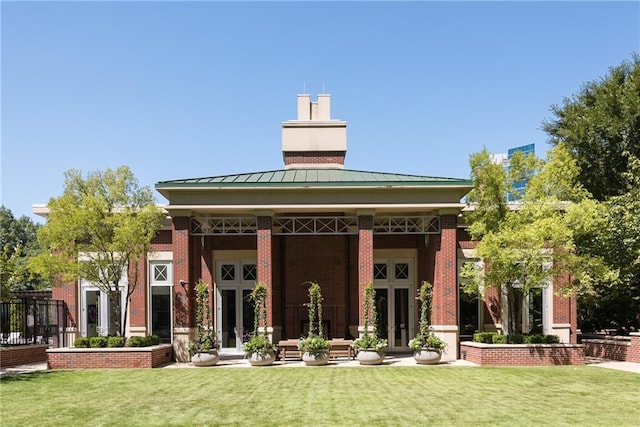 1820 Peachtree St NW Unit 811, Atlanta, GA 30309 - back of property featuring a standing seam roof, a lawn, a chimney, and metal roof