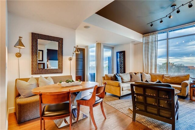 1820 Peachtree St NW Unit 811, Atlanta, GA 30309 - dining area with light wood-style floors and rail lighting
