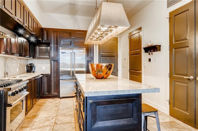 1820 Peachtree St NW Unit 811, Atlanta, GA 30309 - kitchen with high quality appliances, a sink, backsplash, light stone countertops, and a center island