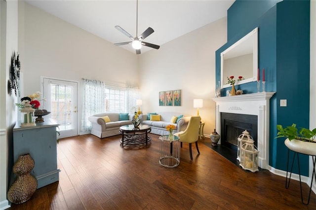 living room featuring ceiling fan, dark wood-type flooring, and high vaulted ceiling