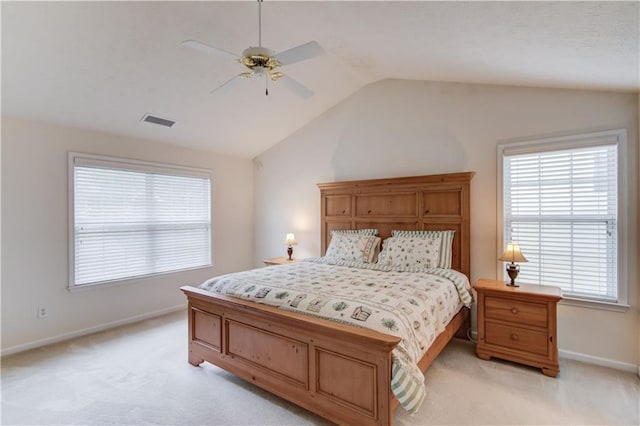 bedroom featuring light carpet, baseboards, lofted ceiling, and multiple windows