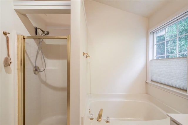 bathroom with a stall shower and a bath