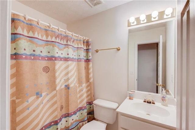 full bathroom with toilet, vanity, and curtained shower