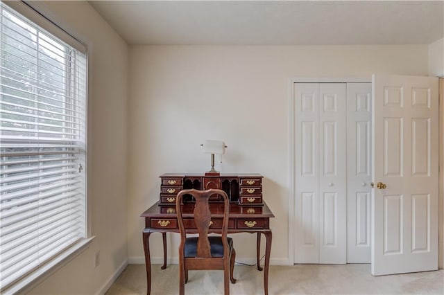 office featuring light carpet and baseboards