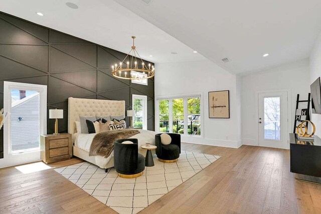 1598 Athens Ave, Atlanta, GA 30310 - bedroom with multiple windows, light wood-type flooring, and a chandelier