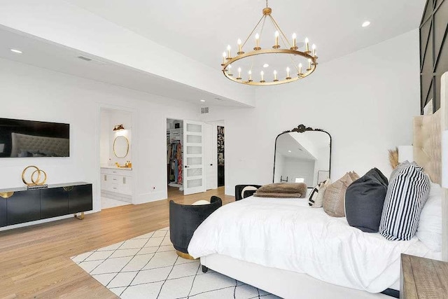 1598 Athens Ave, Atlanta, GA 30310 - bedroom with recessed lighting, a spacious closet, a chandelier, ensuite bath, and light wood-style floors