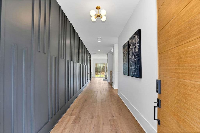 1598 Athens Ave, Atlanta, GA 30310 - corridor featuring baseboards, light wood-style floors, and a chandelier