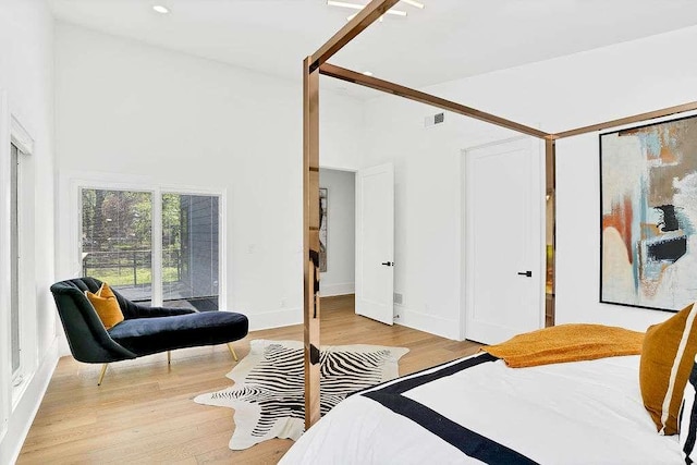 1598 Athens Ave, Atlanta, GA 30310 - bedroom with baseboards, visible vents, light wood-style floors, and a towering ceiling