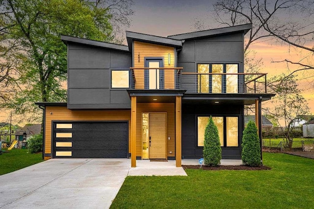 1598 Athens Ave, Atlanta, GA 30310 - contemporary house with a balcony, concrete driveway, a yard, and an attached garage
