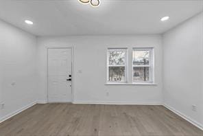 unfurnished room featuring recessed lighting, dark wood-style flooring, and baseboards