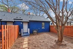 back of property with a fenced backyard