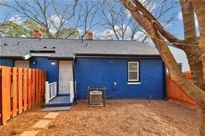 rear view of property featuring fence