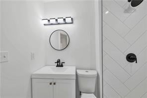 bathroom featuring toilet and vanity