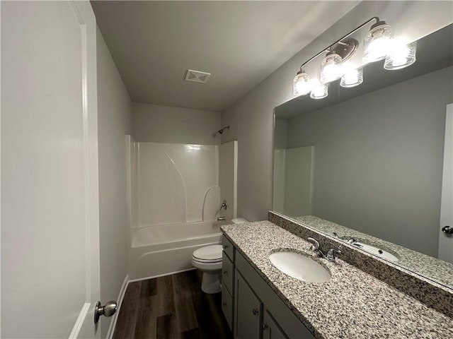 full bathroom featuring vanity, wood finished floors, visible vents, shower / bathing tub combination, and toilet