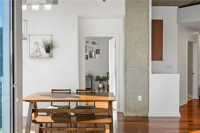 dining area with dark hardwood / wood-style floors