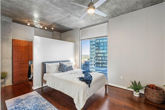 bedroom with ceiling fan, dark wood-type flooring, and floor to ceiling windows