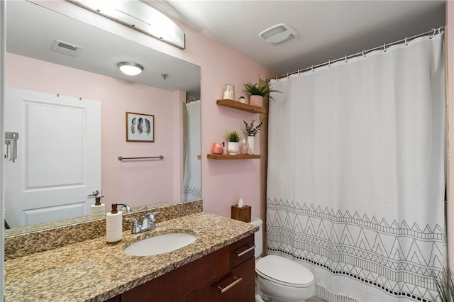 bathroom with toilet and vanity