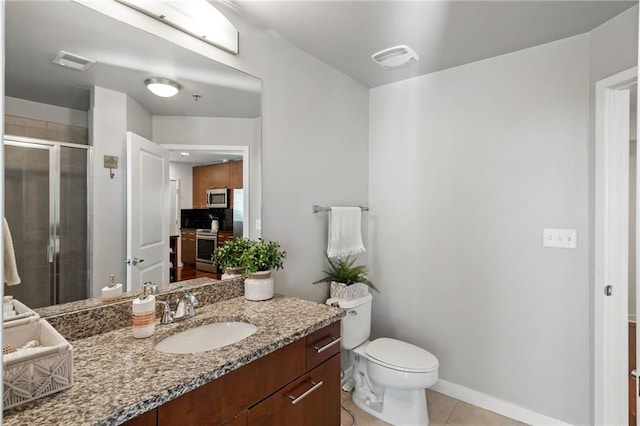 bathroom featuring toilet, tile patterned floors, walk in shower, and vanity