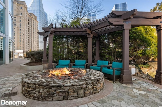 view of patio / terrace with a pergola and an outdoor living space with a fire pit