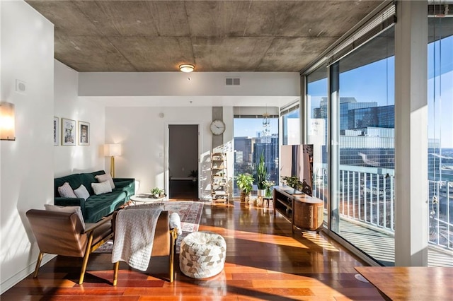 interior space featuring a wall of windows and hardwood / wood-style flooring