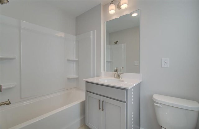 bathroom with tub / shower combination, vanity, and toilet