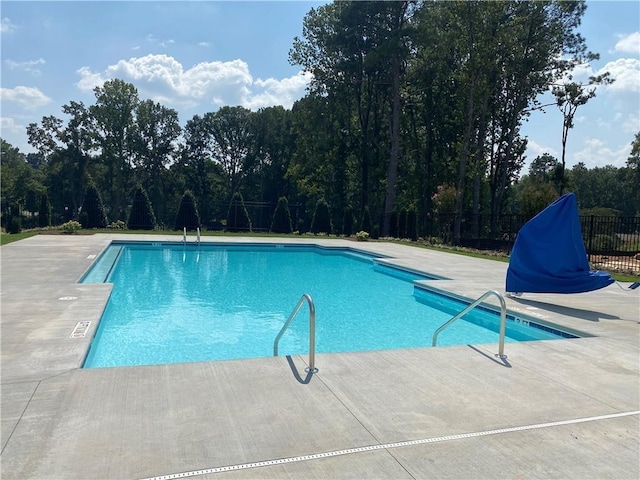 community pool featuring fence and a patio