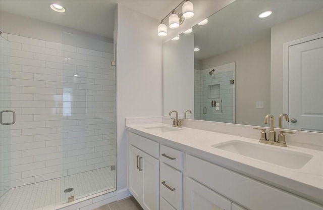 full bathroom featuring a stall shower, a sink, recessed lighting, and double vanity