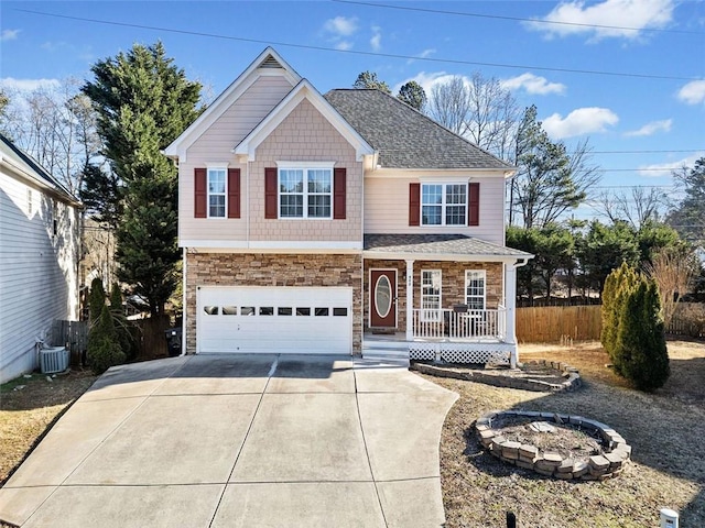 view of front of home with a garage, a porch, and central air condition unit