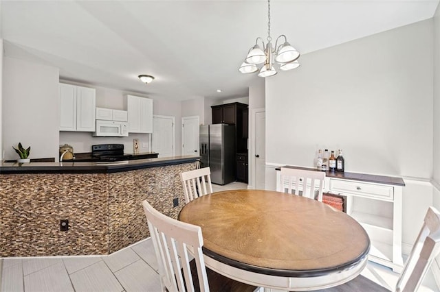 dining space with an inviting chandelier