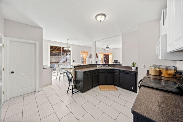 kitchen featuring pendant lighting, black appliances, sink, a kitchen breakfast bar, and kitchen peninsula