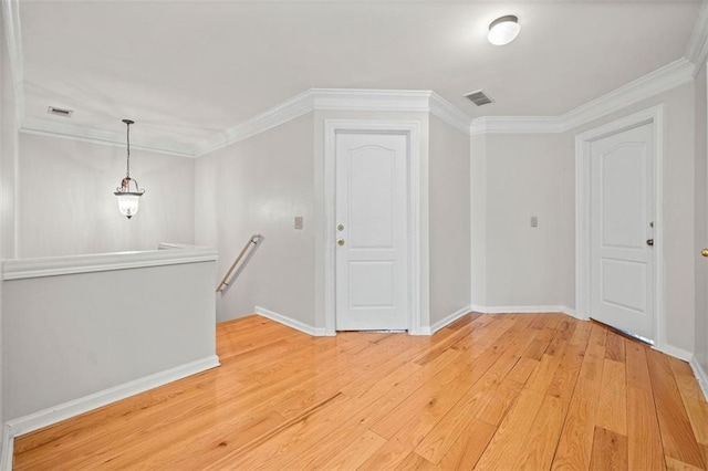 interior space with wood-type flooring and crown molding