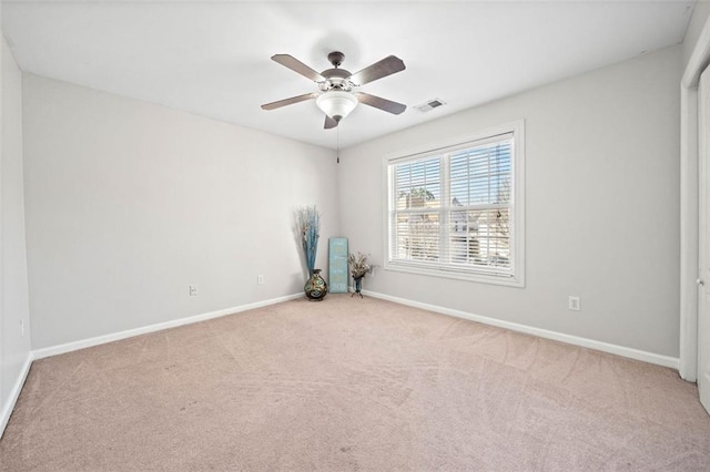 carpeted empty room featuring ceiling fan