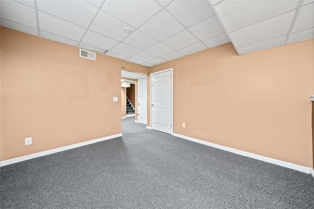 spare room with carpet flooring and a drop ceiling