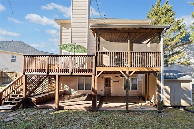 rear view of property featuring a deck and a patio area