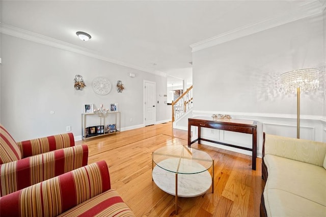 living room with crown molding and hardwood / wood-style flooring