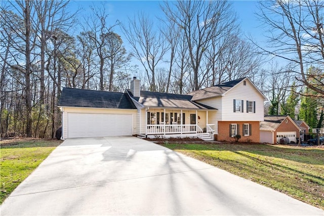 view of front of property with covered porch, a front lawn, and a garage