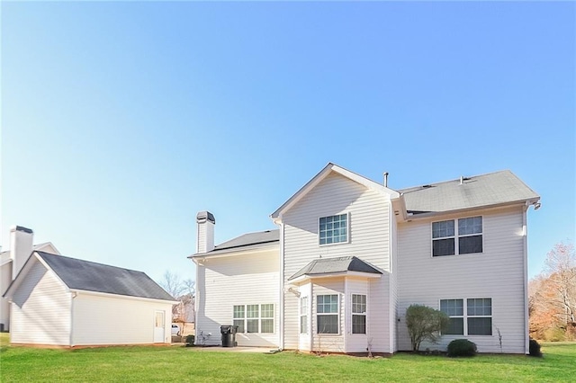 122 Melrose Creek Dr, Stockbridge, GA 30281 - back of property with a lawn and a chimney