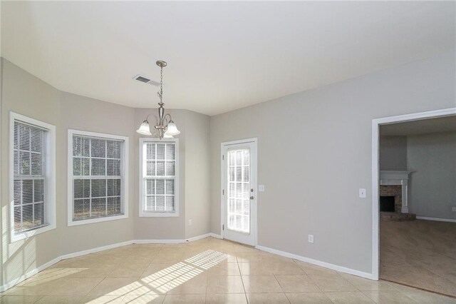 122 Melrose Creek Dr, Stockbridge, GA 30281 - unfurnished dining area featuring light tile patterned floors, baseboards, a chandelier, and a fireplace with raised hearth