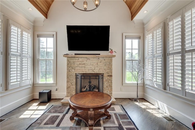 living room with light hardwood / wood-style flooring, lofted ceiling, and a healthy amount of sunlight