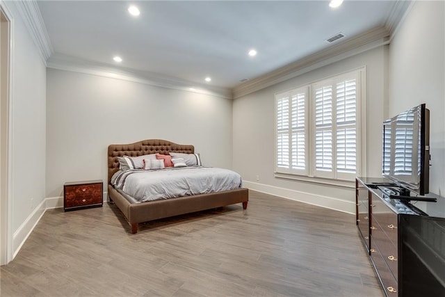 bedroom with crown molding and hardwood / wood-style floors