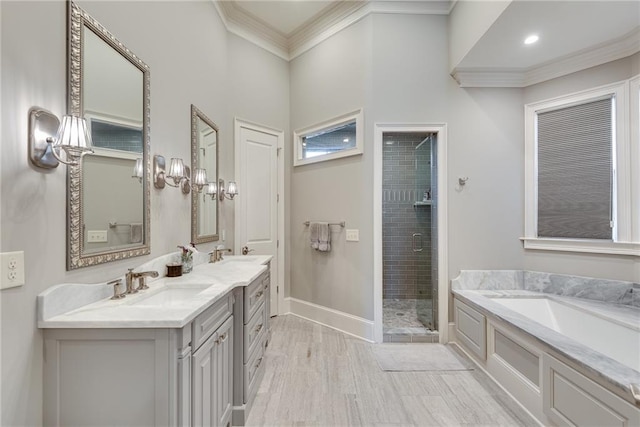 bathroom featuring vanity, ornamental molding, and separate shower and tub