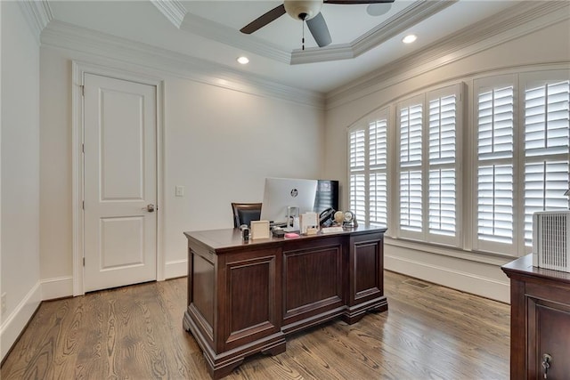 office area with crown molding, a tray ceiling, light wood-type flooring, and ceiling fan