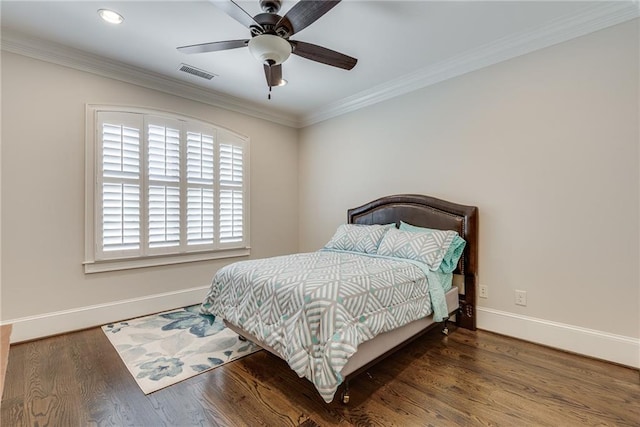 bedroom featuring ornamental molding, wood-type flooring, and ceiling fan