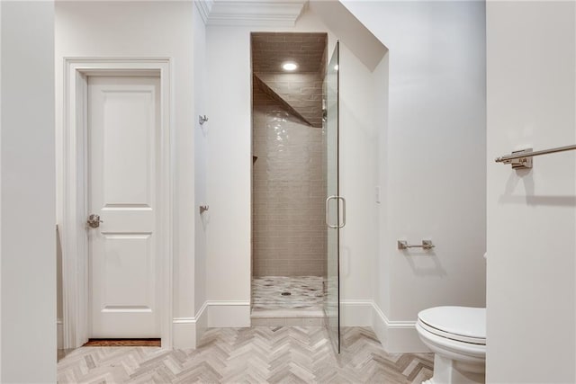 bathroom featuring toilet, an enclosed shower, and parquet flooring