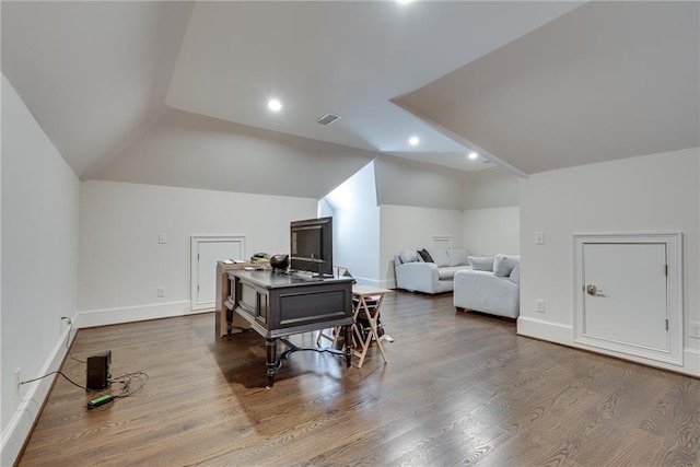 interior space featuring wood-type flooring and vaulted ceiling